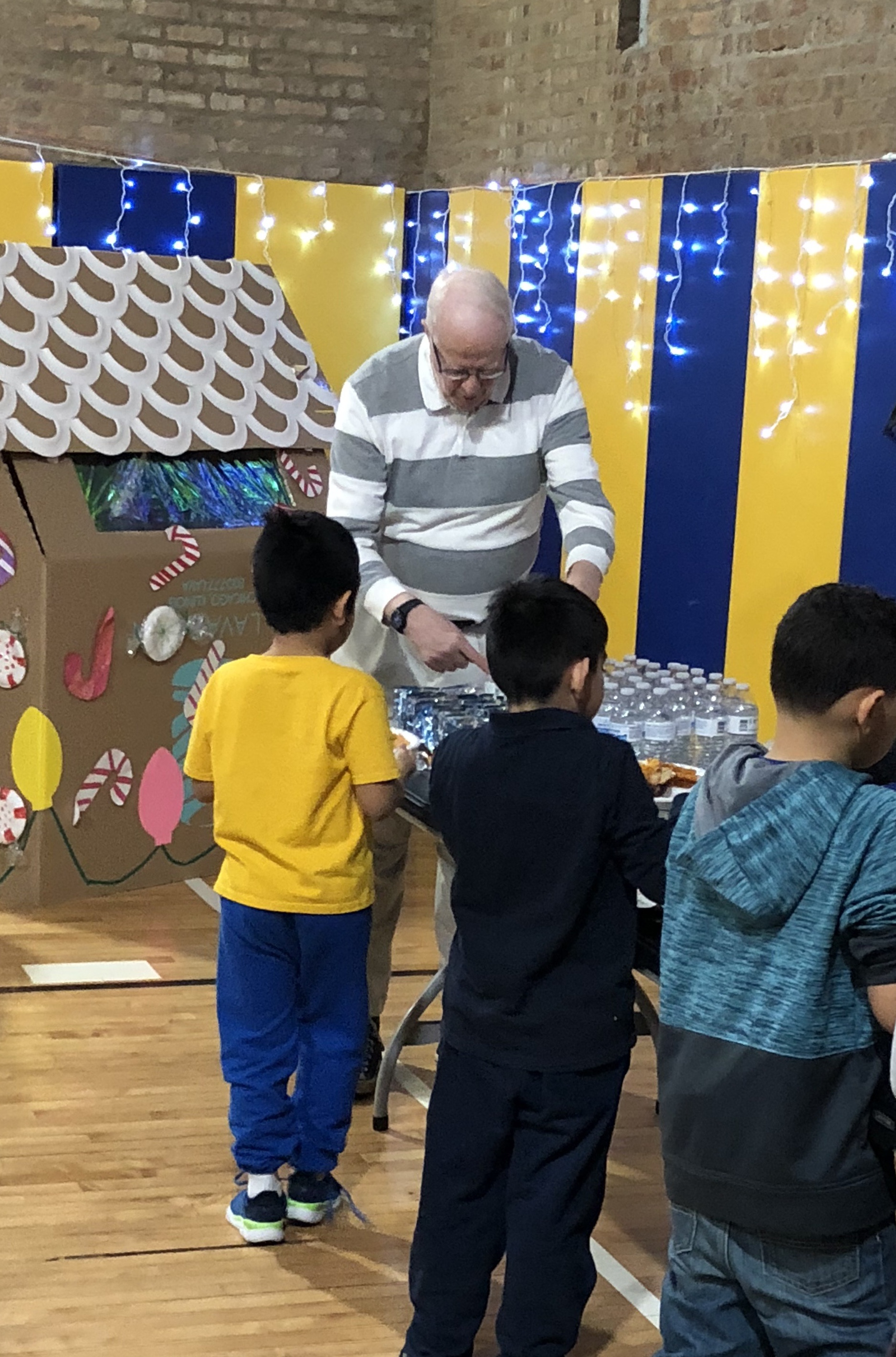 James P. Brett serves holiday treats to a GHC youth program participant.